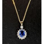 A sapphire and diamond pendant, central sapphire surrounded by diamonds on 18k gold chain 4.7gms