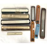 A collection of thermometers; slide rules; etc.