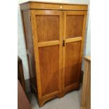 A 1930's gent's golden oak wardrobe with 2 drawers, part fitted
