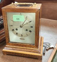 A 19th century French mantle clock in inlaid rosewood case with silvered dial and striking
