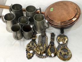 A 19th century copper warming pan and kettle; horse brasses; pewter tankards; etc.