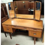 A 1960's teak 2 piece bedroom suite by Butilux, comprising kneehole dressing table and 4 height