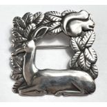 Georg Jensen: A square openwork brooch with resting deer and squirrel in foliage, designed by Arno