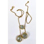 A late Victorian necklace pendant with 3 aquamarine stones in 18 carat gold filigree and scroll