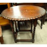 A 1930's oak barley twist occasional table with oval top; a mahogany occasional table/magazine rack