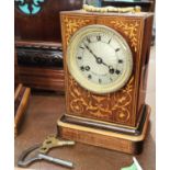 A 19th century French mantle clock in inlaid rosewood case with silvered dial and striking
