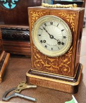 A 19th century French mantle clock in inlaid rosewood case with silvered dial and striking