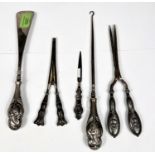 A hallmarked silver shoehorn and button hook set, cherub embossed, Birmingham 1903; a similar pair