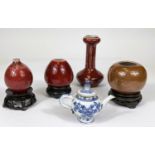 Three small oxblood glaze Chinese vases, two squat bulbous and a slender neck, other hts. 12cm,