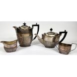 A hallmarked silver matched 4 piece oval tea set, Georgian style with reeded lower bodies,