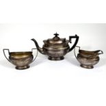 A hallmarked silver 3 piece oval Georgian style tea set with ribbed line decoration and raised