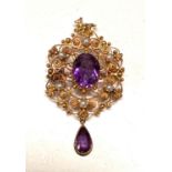 A yellow metal filigree pendant brooch set seed pearls and 2 amethysts, stamped '15c', 5gm