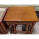 An oak 2 tier coffee table; a nest of 3 oak occasional tables