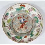A finely decorated Chinese saucer with polychrome decoration of deity riding dragon with floral