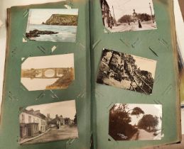 A late 19th/early 20th century postcard album with various cards and ephemera