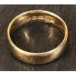 An 18 carat hallmarked gold large wedding ring, size S/T, 9.3gm