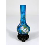 A Chinese light blue glass vase with decoration of fruit and bats on trees with signature to base