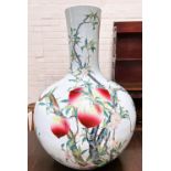 A very large Chinese bottle vase decorated with polychrome peaches and flowers on branches with seal