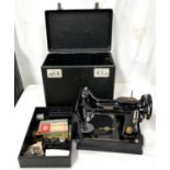 A vintage small black cased Singer sewing machine with accessories