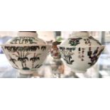 A matched pair of Chinese ceramic Republic period lidded cups with polychrome decoration and red