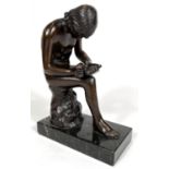 A bronze nude man, seated and pulling a thorn from his foot, on marble base, unsigned, height 18cm