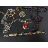 Two silver crosses set coloured stones, on chains; 2 pendants; a bead necklace; 4 rings set large