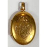 A yellow metal oval pendant locket, monogrammed,  unmarked, tests as circa 18ct, 4.5gm