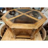 An octagonal 2 tier coffee table with glass top