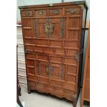 An early 20th century Korean Tansu 'marriage' chest on chest with brass bindings and butterfly