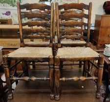 Four Titchmarsh and Goodwin rush seat dining chairs with ladder backs.