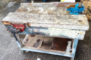 A vintage work bench with attached clamps, vintage cupboard with tools, chisels etc