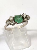 A platinum stamped Art Deco dress ring, square cut emerald approximately 6mm x 6mm with bevelled and