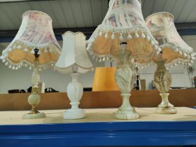 An onyx standard lamp and four similar lamps