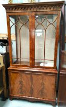 A mahogany reproduction full height display/book case with double figured doors below and astragal