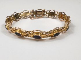 An Edwardian 9ct gold amethyst set (12 stones) bracelet, 9.2gms.