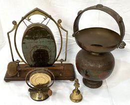 An Arts and Crafts table gong, brass on a wooden base; a brass spittoon; other similar items.