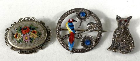 A sterling silver brooch with enamelled bird in flowers, set 2 blue tones; a white metal brooch