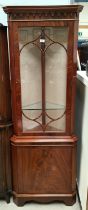 A mahogany full height reproduction glazed corner cupboard with figured solid door below and
