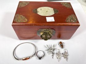 An amber set bangle and bee brooch stamped 925; a silver fairy brooch and matching earrings; a