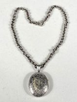 A hallmarked silver Victorian oval locket with wave pattern, marks worn, possibly Birmingham 1840,