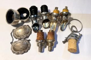 A selection of silver bottle pourers, two silver napkin rings etc