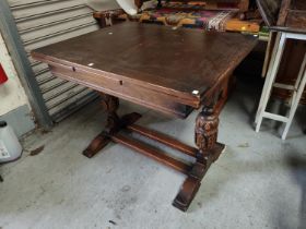 An oak draw leaf dining table with bulbous legs and an oak carved wooden buffet sideboard with