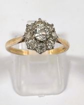 An 18 carat hallmarked gold ring set central diamond, 5mm approx., surrounded by 8 smaller stones,