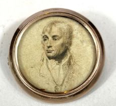A gold plated brooch, double sided with prints depicting Nelson and 2 children