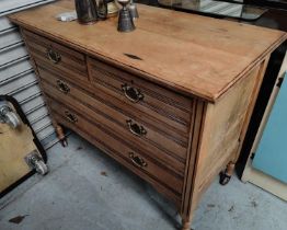 An Edwardian stripped wood chest of 2 long and 2 short drawers