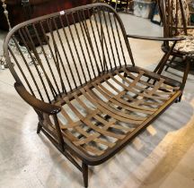 A two seater Ercol stick back low settee with rounded back, length 135cm.