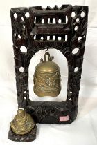 A Buddhist wooden and brass temple style bell with plural decoration inset with similar highlights