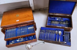 A large oak canteen of silver plated cutlery, hinged lid and two drawers below; a smaller similar