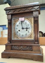 An Edwardian oak cased mantel clock with strike