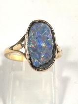 An 18ct gold oval shaped black opal (14mm x 9mm) doublet ring, 3.37gms, ring size K/L.